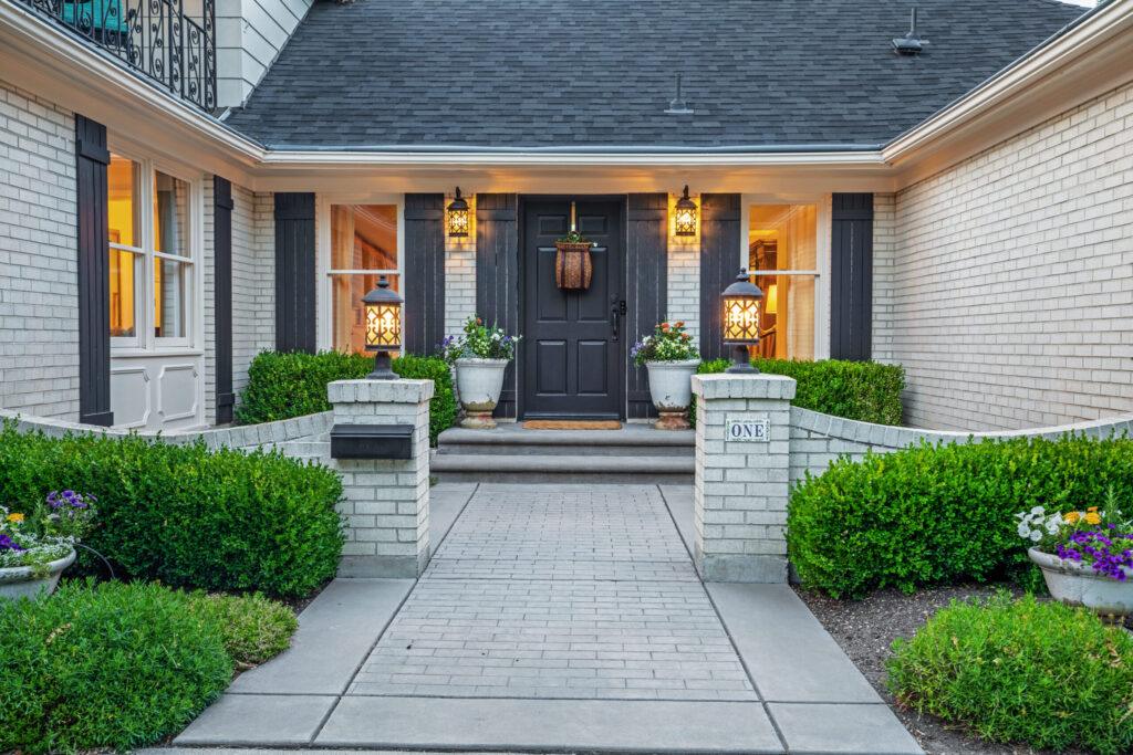 Front entrance of a modern home with stone walkway and landscaping.