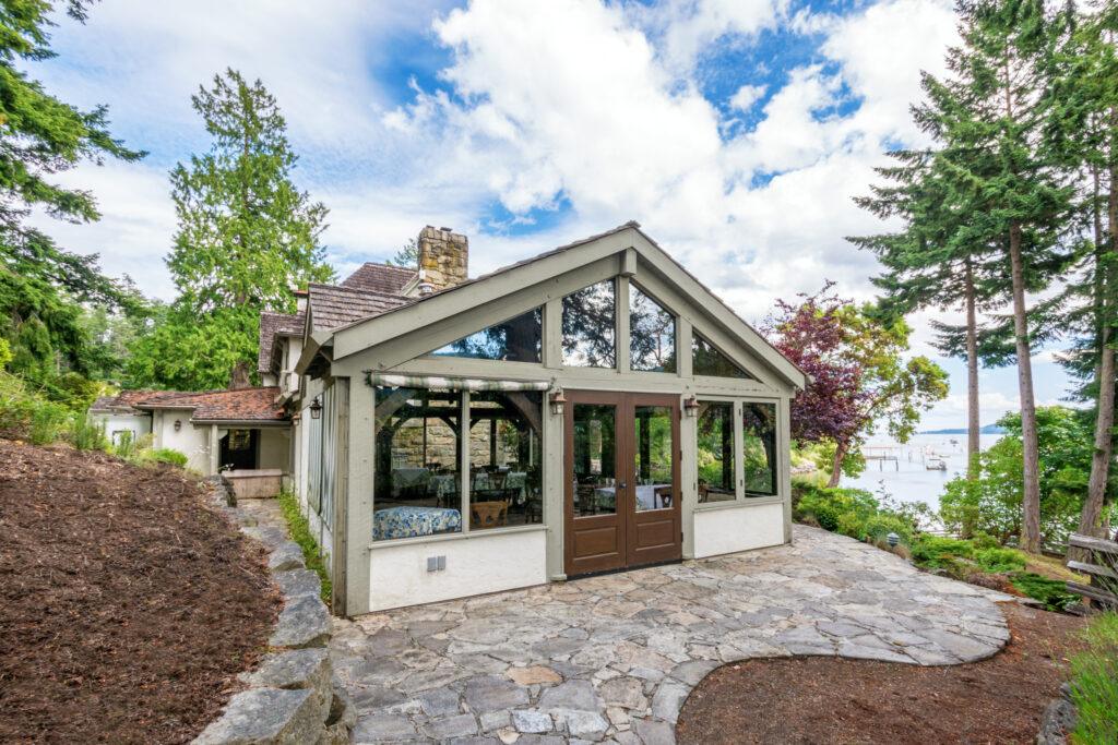 Residential sunroom with vaulted ceilings and full window walls.