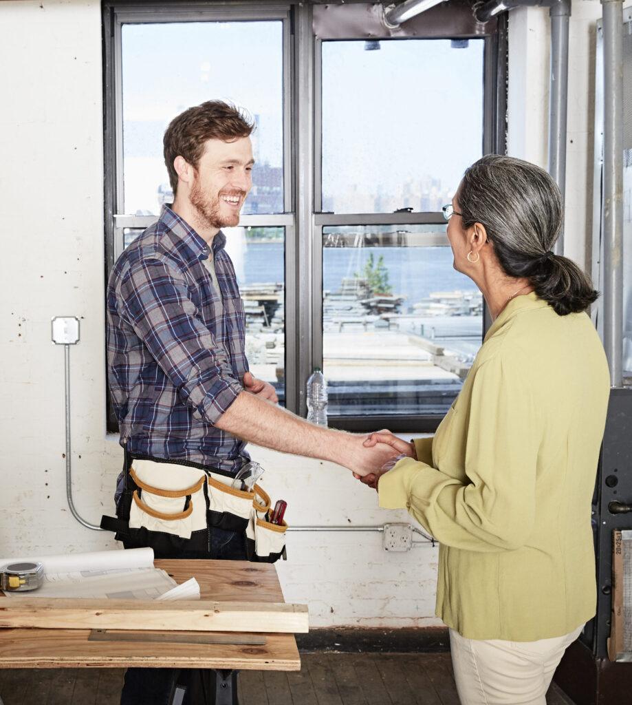 Contractor speaking with homeowner in a newly remodeled kitchen.
