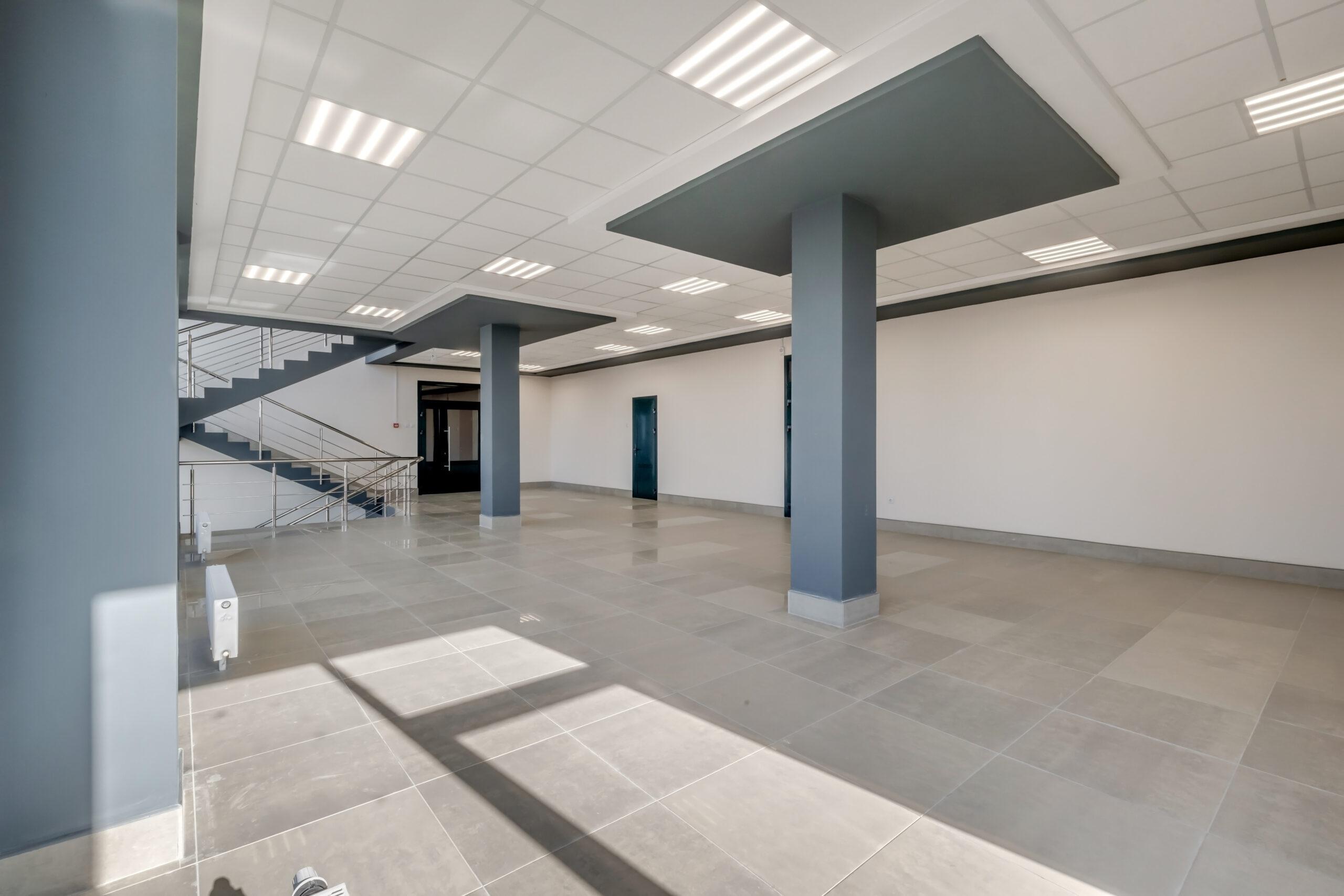 Empty commercial interior prepared for tenant fit-out with open floor plan and structural columns